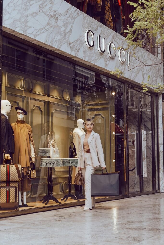 Elegant woman walks by Gucci store in Istanbul, shopping luxury fashion items.